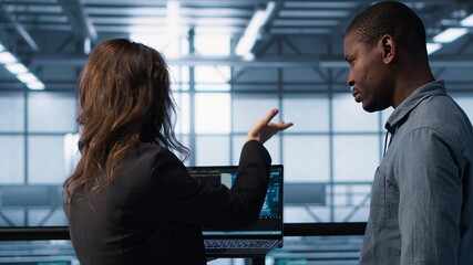 AI technology used by data center software developers reviewing equipment diagnostics. Programmers...