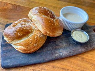 Freshly baked Bavarian pretzels (Bretzels). Pretzel rolls of buns with dipping sauce.