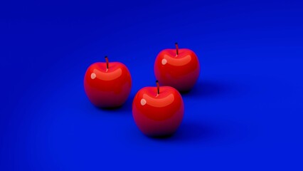 Obraz premium Three red apples on solid blue background....