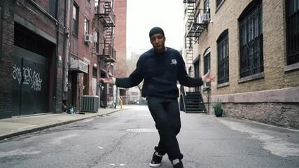 Urban Hip Hop Dancer in Motion, Energetic Street Style Performance in a Gritty City Alleyway.. High quality professional video perfect for commercial use and marketing projects.