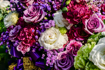 Beautiful flowers bouquet in different color tone and styles in Thailand market, nice background textures. Thai orchids, roses, carnations etc. Close up shot.