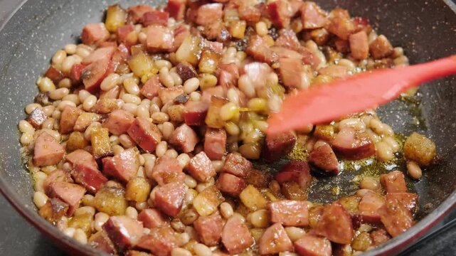 Brazilian food, feijao tropeiro, bacon and Calabrian sausage