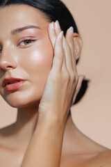 Closeup Of Latina Woman Highlighting Radiant Skin With A Soft Pose 