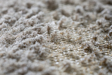Dirty metal exhaust filter long overdue for cleaning. Close up of dust layer with grease droplets,...