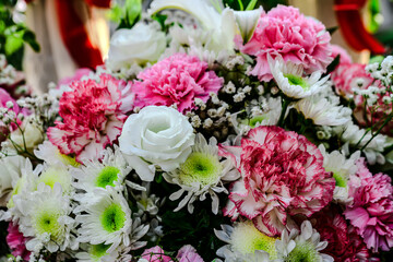 Beautiful flowers bouquet in different color tone and styles in Thailand market, nice background textures. Thai orchids, roses, carnations etc. Close up shot.