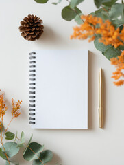 Some decorations are placed around the blank notebook
