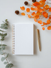 Some decorations are placed around the blank notebook
