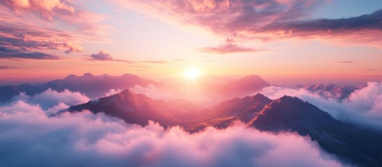 Sunrise over mountains shrouded in clouds
