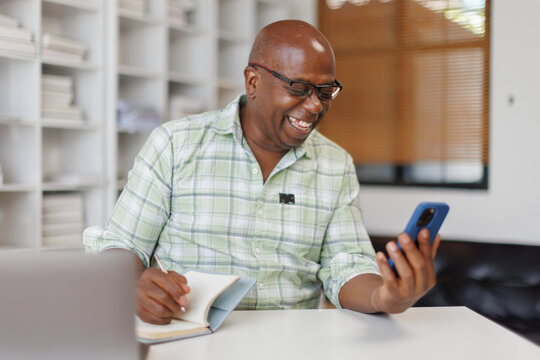  Senior man  business man using laptop and using phone note, Senior man officer hard working communicate with customer and record business concept
