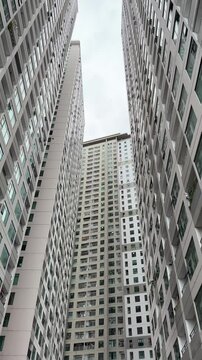 Vietnam, Nha Trang - 29.05.2025 - Skyscrapers, view from the bottom up, large buildings, man, high-rise building in Asia, luxury residential complex Oceanus, Muntian