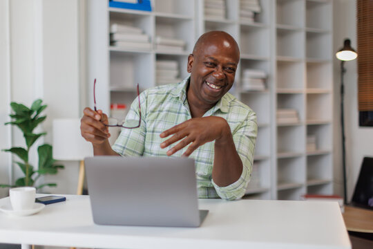 Happy senior ma, business man sitting working with a laptop computer in the office.
- Powered by Adobe