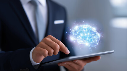 Businessman interacting with a digital brain hologram above a tablet screen.
