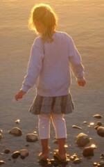 Little girl stares into the lake