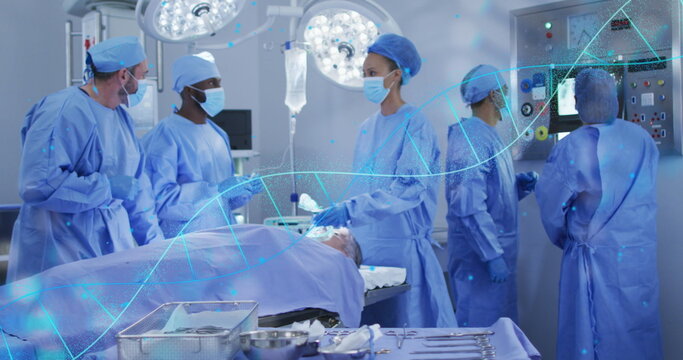 Image of dna strand over diverse surgeons during surgery