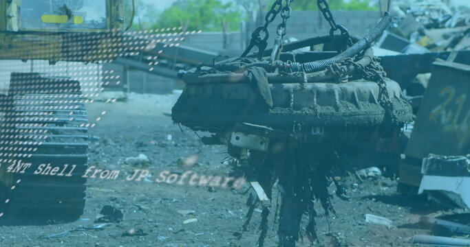 Hoisting electromagnet lifter raising corroded engine block over scrap yard, with heavy chains - Powered by Adobe