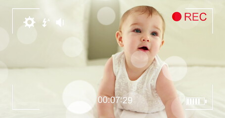 Image of falling dots over happy caucasian happy baby