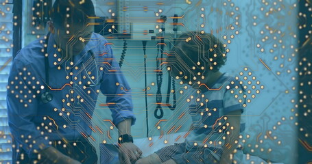 Microprocessor connections against asian male doctor examining caucasian boy's knee at hospital