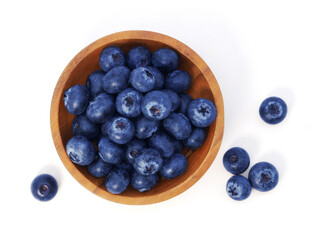 Blueberries in wooden bowl isolated on white background