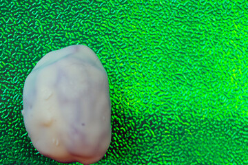 Chocolate dates alone with bright color, bright green background is very much in demand
