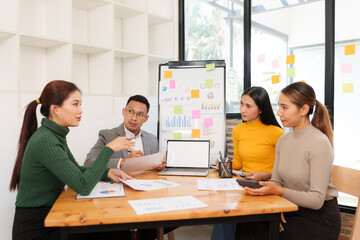 Group of Asian business people working together in an office