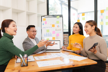 Group of Asian business people working together in an office