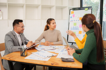 Group of Asian business people working together in an office