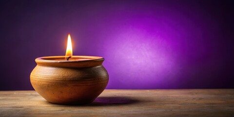 Serene ambiance with candle in earthen pot on purple background