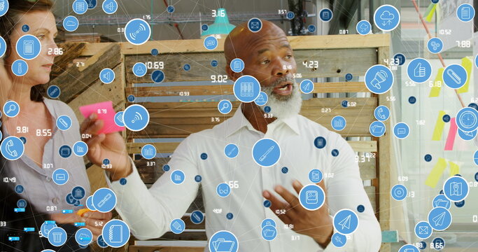 Image of data processing over diverse business people taking notes