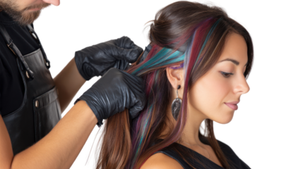 Hair stylist applying colorful highlights to a woman's hair.