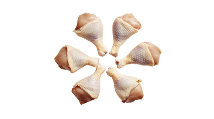 Raw chicken drumsticks arranged in a flower pattern, white isolated background.