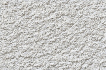 A detailed close-up of a textured wall surface, showcasing a rough, uneven texture