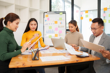 Group of Asian business people working together in an office