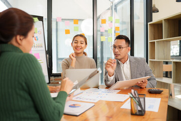 Group of Asian business people working together in an office