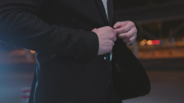 An Elegantly Dressed Man Posing in a Stylish Urban Night Setting, Exuding Confidence and Charm
