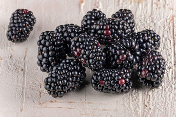 Fresh Ripe Blackberries on rustic light wooden background - macro close-up