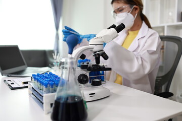 Scientist in laboratory conducting research with advanced equipment, analyzing samples with...