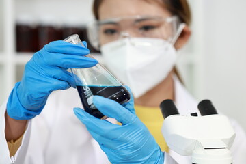 Scientist in laboratory conducting research with advanced equipment, analyzing samples with...