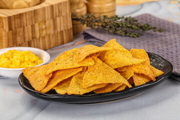 Corn nachos chips with cheese dip