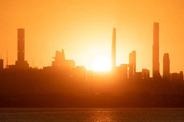 Sun setting behind the Manhattan skyline