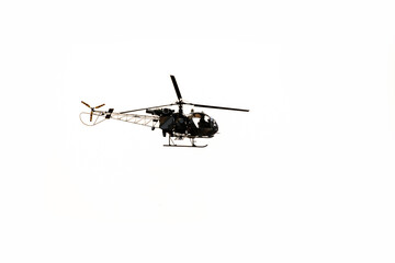 Silhouette helicopter is flying on isolated white background