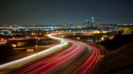 Fototapeta premium A long-exposure shot of a highway at night with streaks of red and white lights from moving cars.