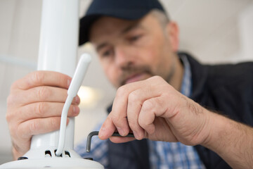 a man assembling office stool