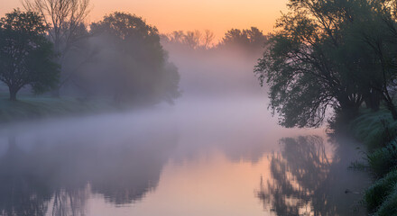 Naklejka premium Serene River Scene With Early Morning Mist And Tranquil Reflections