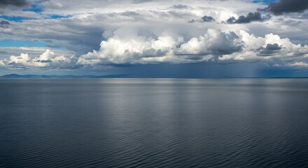 Obraz premium Dramatic Overcast Sky Above the Sea with Approaching Rain Showers
