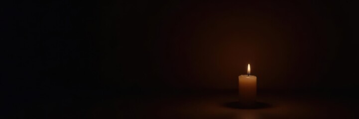 Single flickering candle flame against dark background, symbolic of remembrance , faith, still life, loss