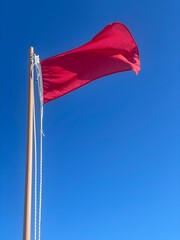 Red flag at a beach. Reports danger to bathing due to adverse weather or absence of lifeguard service. Danger to bathing