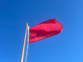 Red flag at a beach. Reports danger to bathing due to adverse weather or absence of lifeguard service. Danger to bathing