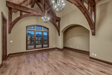 Spacious, light-filled room with vaulted wooden beams and large window.  Tranquil, elegant interior