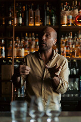 Mexican man talks about mezcal and tequila in a bar, master class