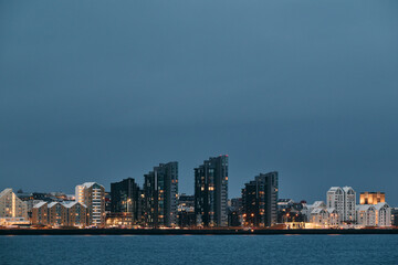 Fototapeta premium Reykjavik city skyline illuminating the dusk sky in iceland